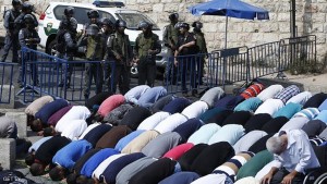 Palestinian Muslim worshippers, under the age of 40 years old, perform the traditional Friday prayers on a street as Israeli police blocks the access to Al-Aqsa Mosque, on October 2, 2015, at Jerusalem's Old City Lion Gate outside the Al-Aqsa mosque compound. AFP PHOTO /AHMAD GHARABLI        (Photo credit should read AHMAD GHARABLI/AFP/Getty Images)